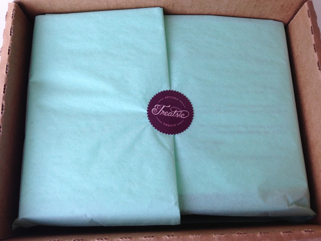 treatsie december box interior with mint green tissue paper and purple sticker