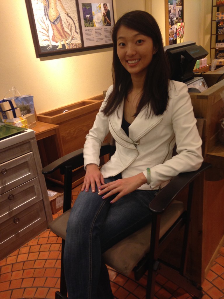 girl sitting in chair at l'occitane store waiting to receive free hand massage