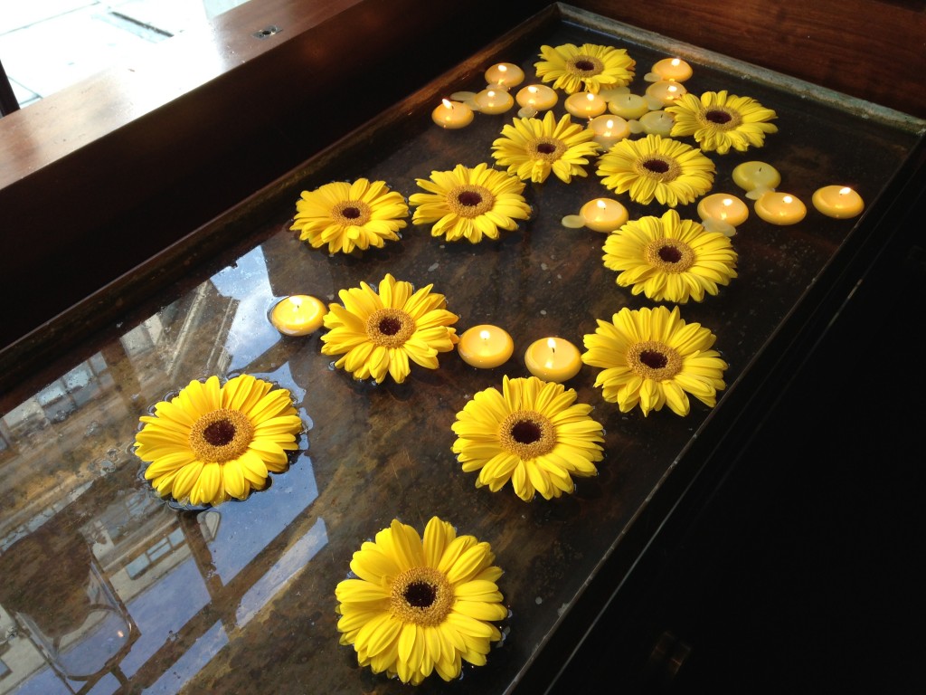 yellow flowers and floating candles on water