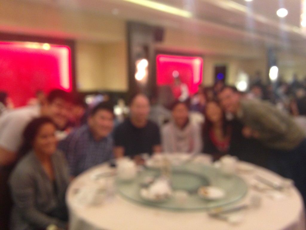 blurry shot of group of friends at dim sum restaurant table