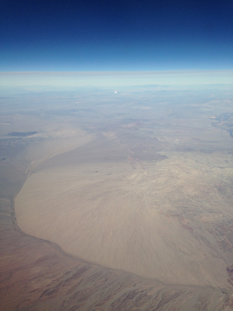 aerial view of land with bright light in distance