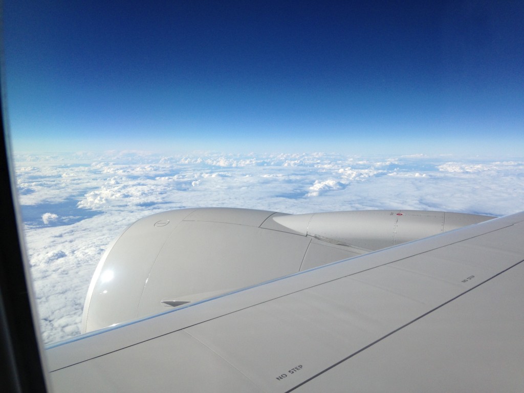 sheet of white clouds viewed over plane wing