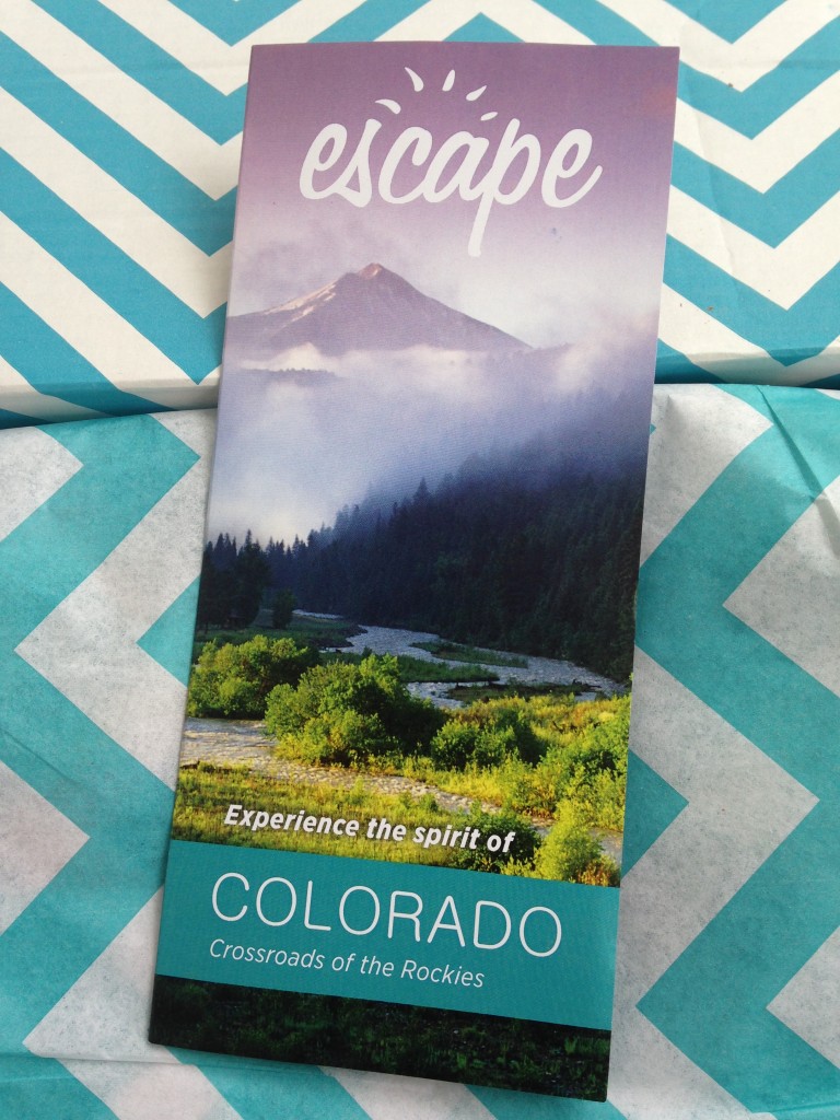 escape monthly january colorado box info card against blue and white chevron background