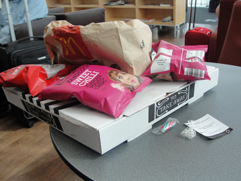 pile of pizza box, bags of chips, and mcdonald's bag