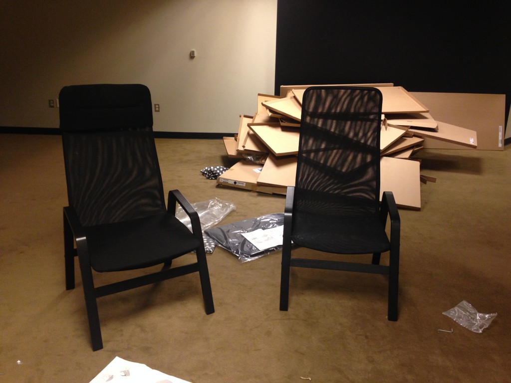 two mesh ikea lawn style chairs freshly built with cardboard boxes in background