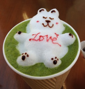 green tea latte drink with 3d latte art bear and the world love written on its belly