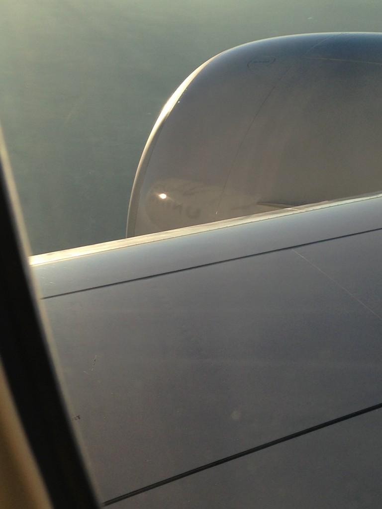 reflection of front of united plane on engine off wing