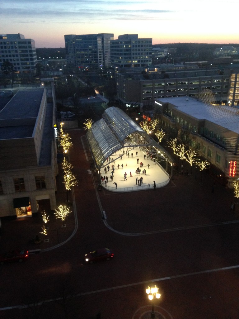 view of reston town center ice rink and sunset in distance from nearby building