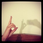 hand casting shadow puppet on wall