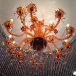 orange brown chandelier surrounded by circle of clear strands