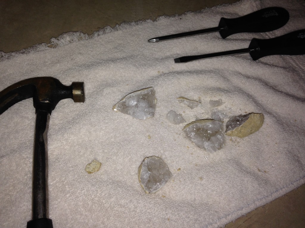 hammer and two screwdrivers used as tools to break apart geode