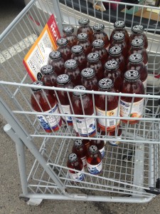 dozens of inko's tea bottles in small whole foods two-tiered shopping cart