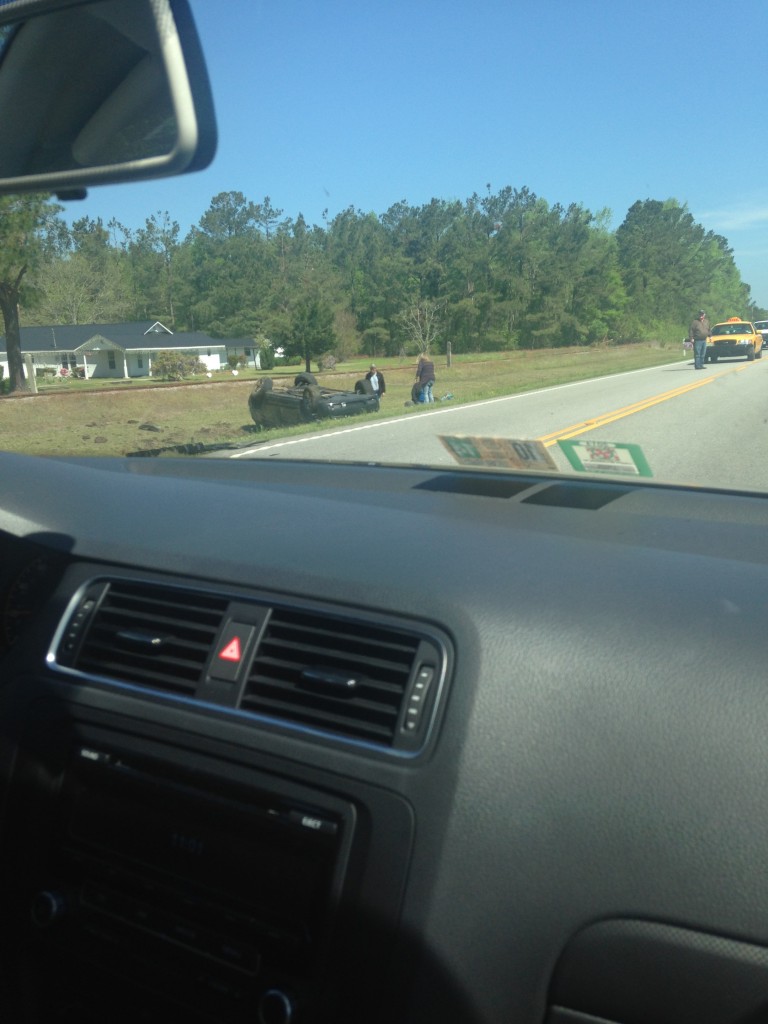 flipped car on side of road