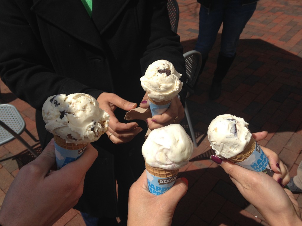 hands holding ice cream cones from ben and jerry's
