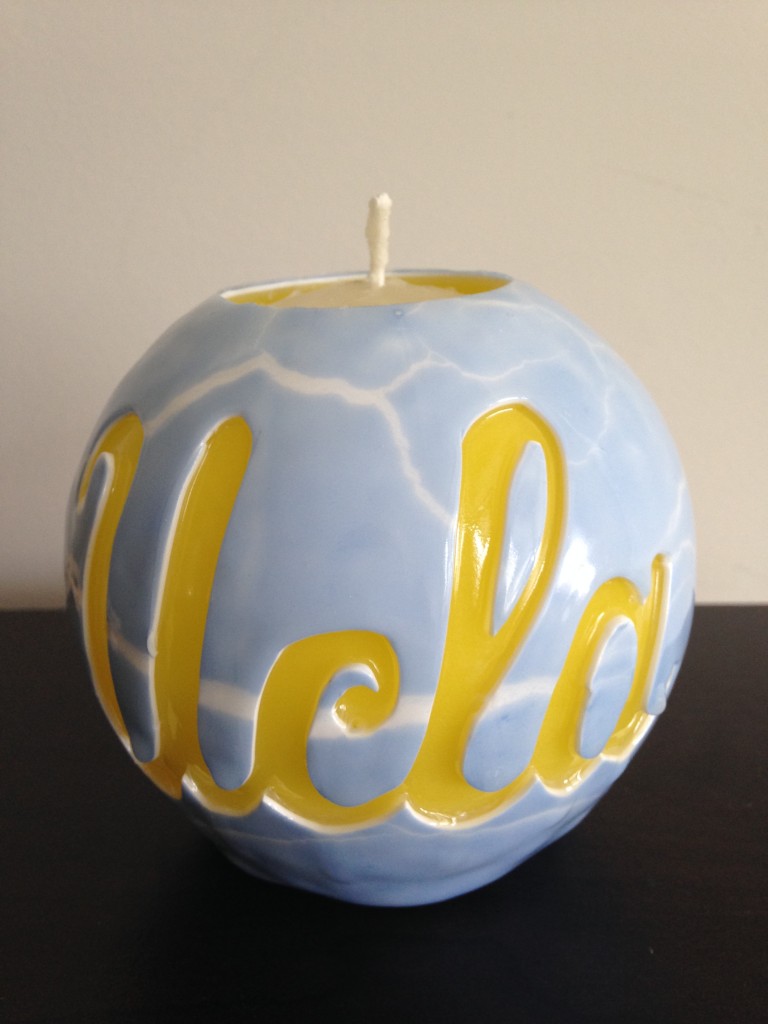 blue and yellow ucla globe candle hand carved