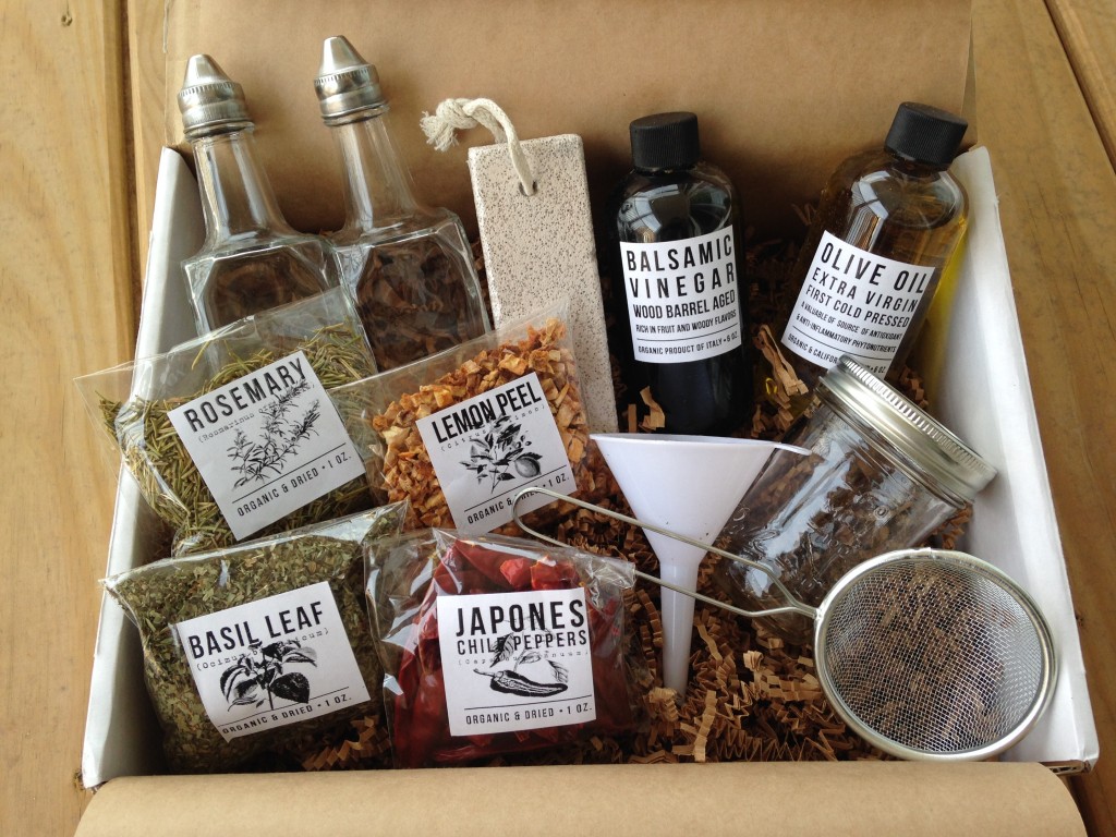 contents of the homegrown collective may 2014 box with olives grapes herbs oh my theme