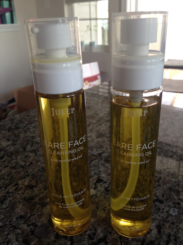 two bottles of julep bare face cleansing oils side by side, with one bottle missing a lot of product