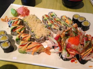 five types of sushi rolls on single platter