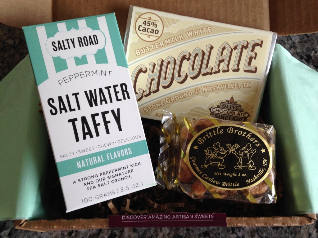 treatsie june 2014 box contents with salty road salt water taffy, olive & sinclair chocolate bar, and brittle brothers cashew brittle
