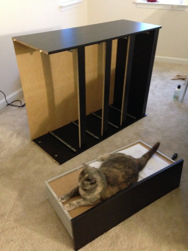 frame of dresser created and cat sitting on upside down drawer nearby