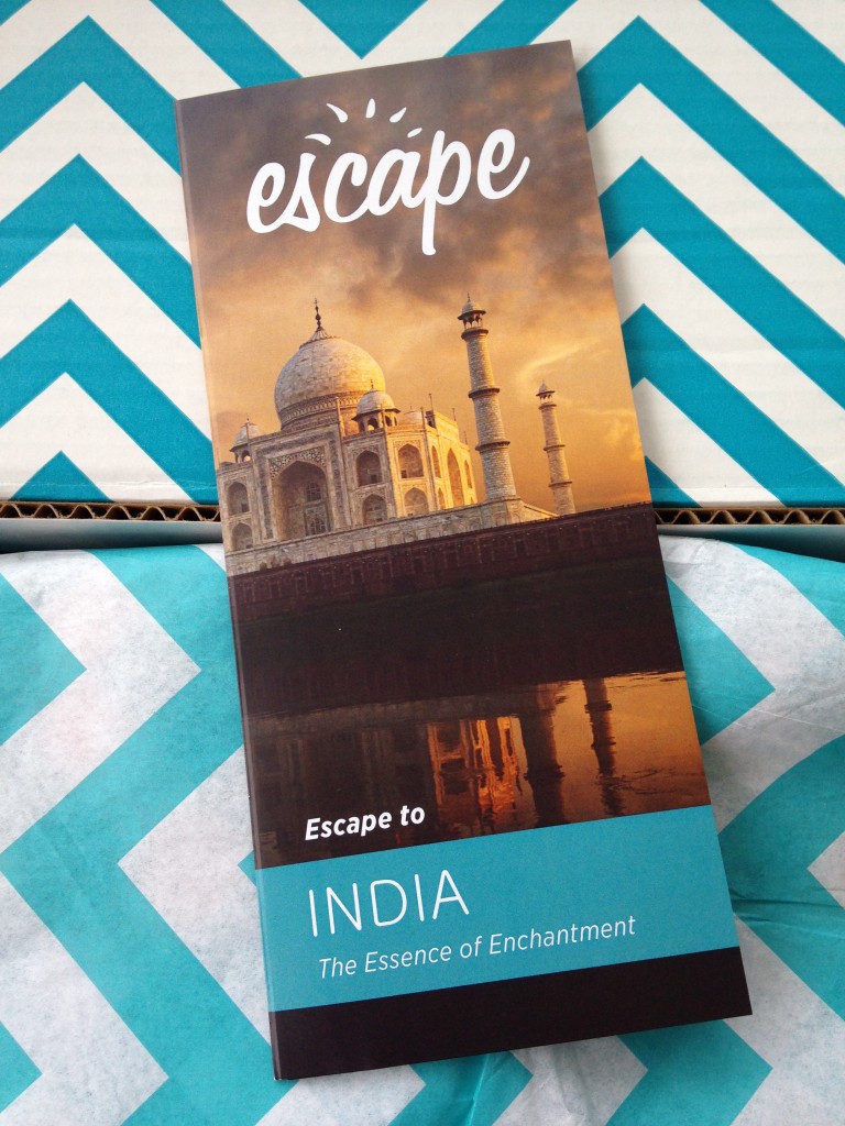 escape monthly july india box info card against blue and white chevron background