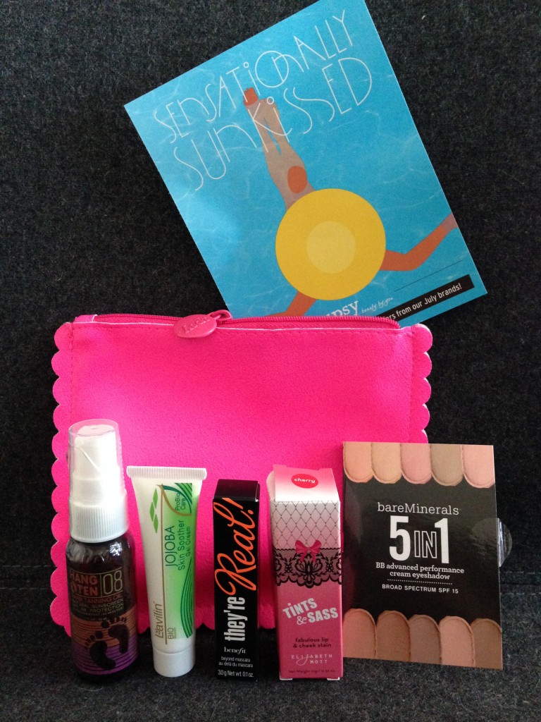 ipsy july 2014 bag items with card including hang ten tanning oil, lavilin jojoba skin soother gel cream, benefit they're real mascara, elizabeth mott tints & sass lip & cheek stain in cherry, and bareminerals 5 in 1 cream eyeshadow in divine wine