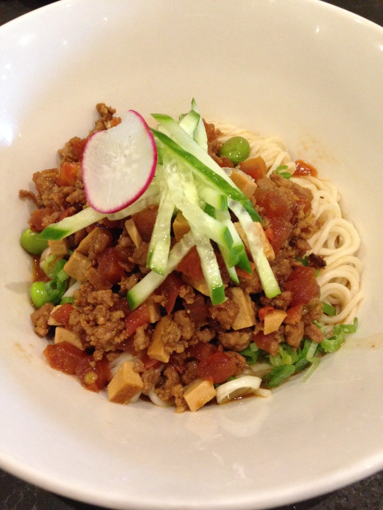 noodles topped with minced pork and cucumber at din tai fung
