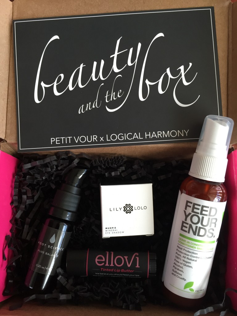 contents of petit vour september 2014 box with root science moisturizer, lily lolo mineral eye shadow, ellovi tinted lip butter, yarok leave-in conditioner, and info card with beauty & the box theme