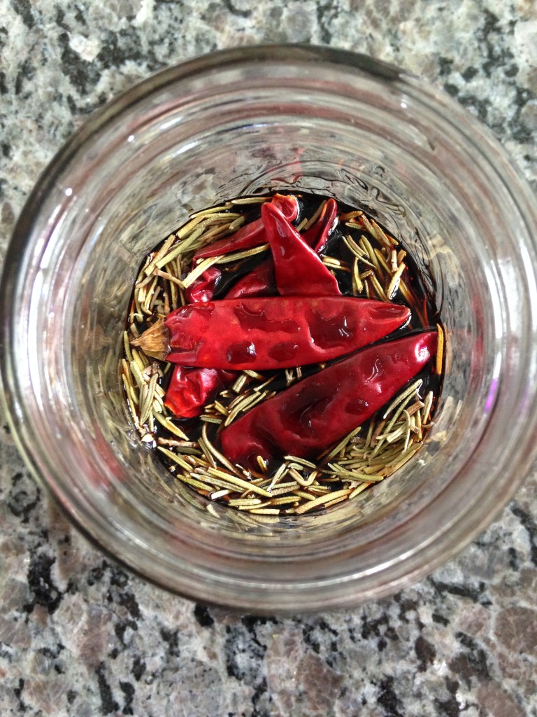 balsamic vinegar infusion in jar with japones peppers and rosemary