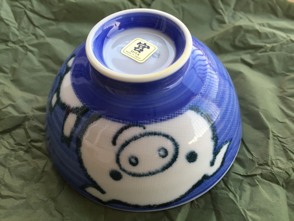 small blue bowl with cartoon pig design on side