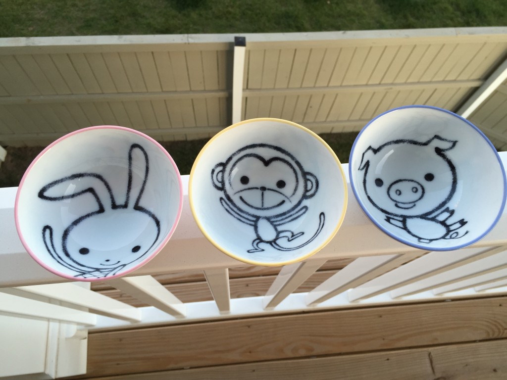 set of three mini bowls with a pink bunny, yellow monkey, and blue pig designs