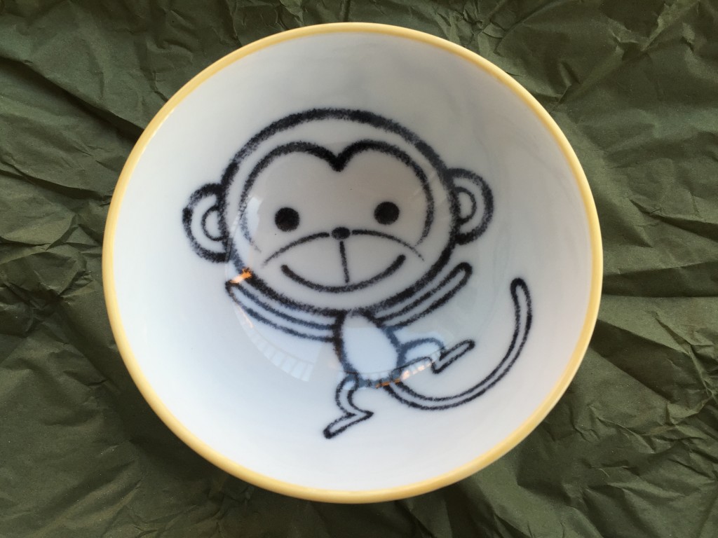 small bowl with cartoon monkey design inside