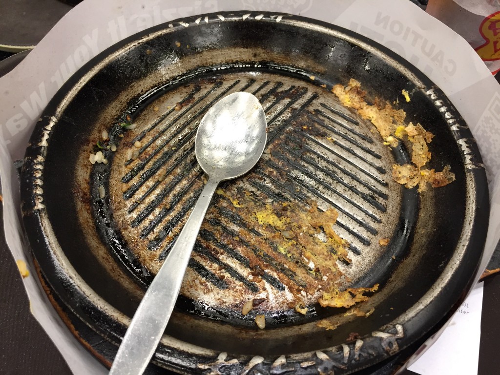 emptry pepper lunch skillet with spoon after meal has been eaten
