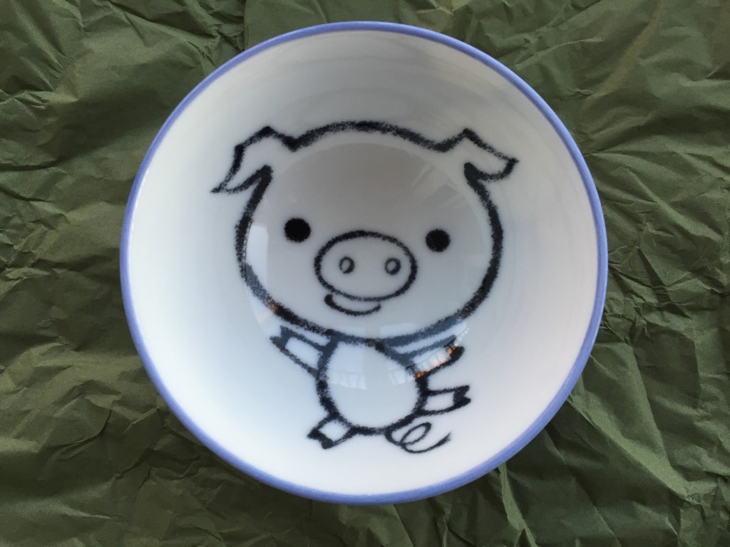 small bowl with cartoon pig design inside