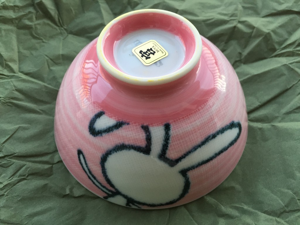 small pink bowl with back of cartoon bunny outline on side