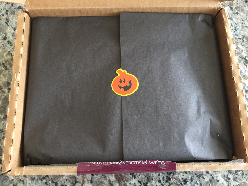 treatsie october 2014 halloween wrapping with black tissue paper and orange pumpkin sticker