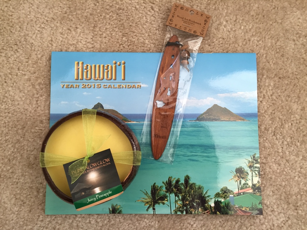 pineapple-scented candle in coconut shell, koa wood bookmark, and hawaii calendar for 2015