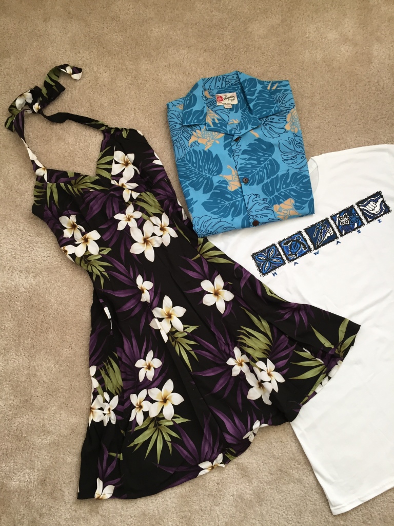 purple halter top dress with white flowers, blue and beige hawaiian shirt, and hawaii t-shirt from hilo hattie