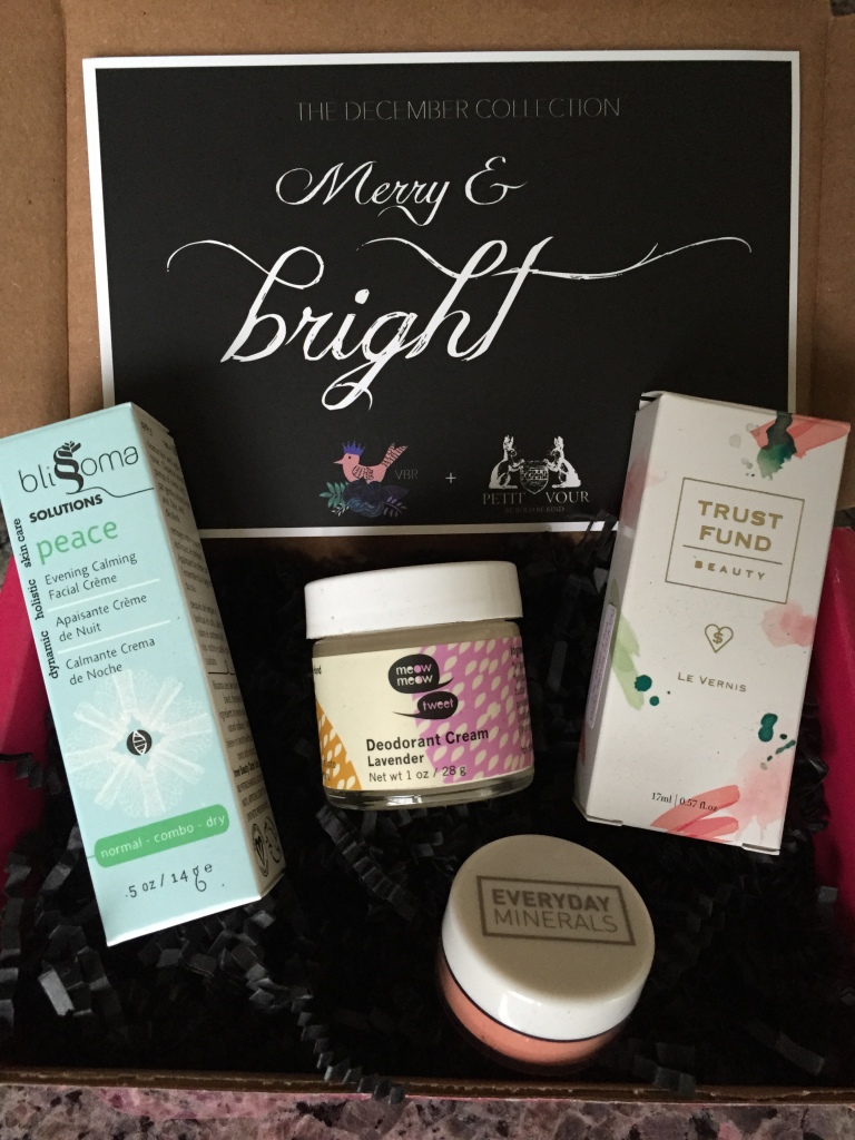 contents of petit vour december 2014 box with blissoma evening calming facial creme, meow meow tweet deodorant cream, everyday minerals matte blush, trust fund beauty nail lacquer, and info card with merry & bright theme