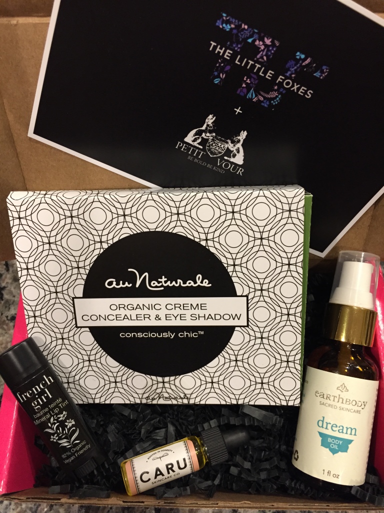 contents of petit vour november 2014 box with au naturale creme concealer & eye shadow, french girl mineral lip tint, caru skincare facial serum, earthbody skincare body oil, and info card with natural givers theme
