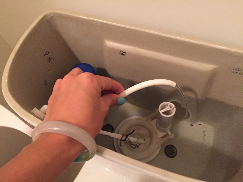 tube of water from toilet running after flush