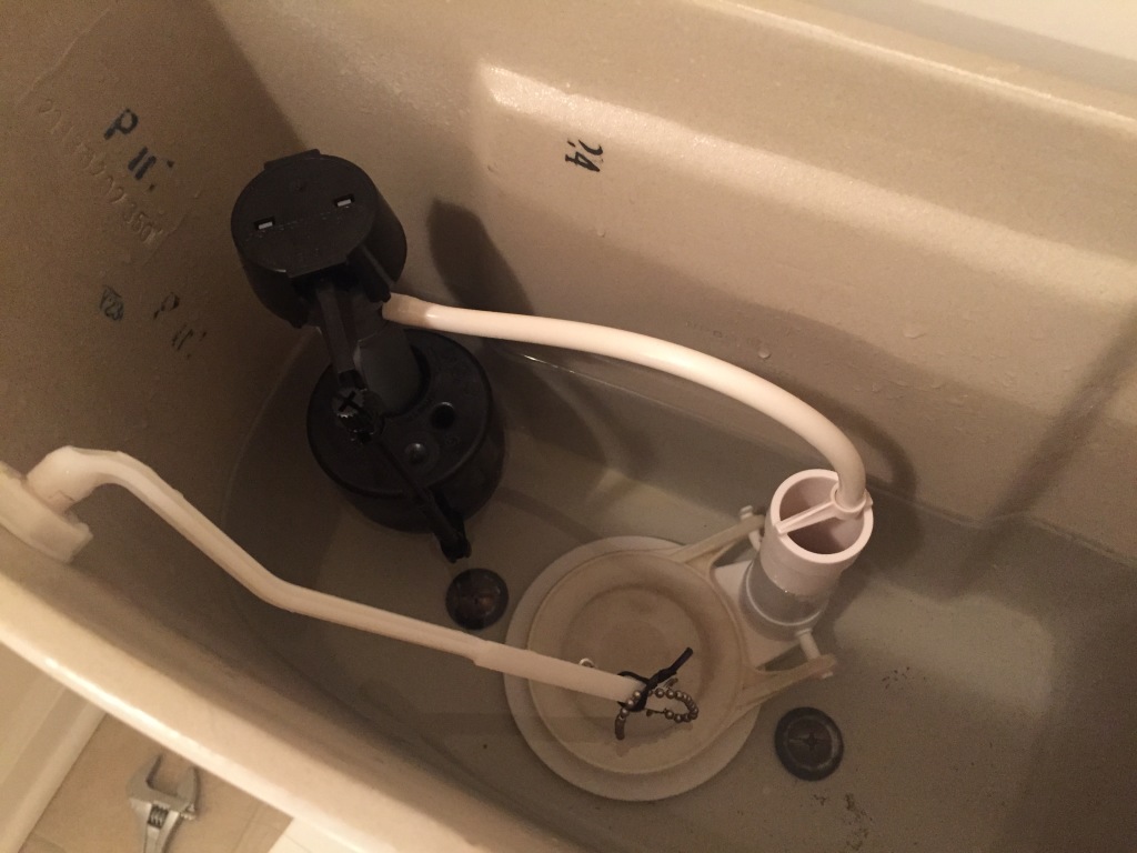 inside of toilet tank with newly replaced toilet float