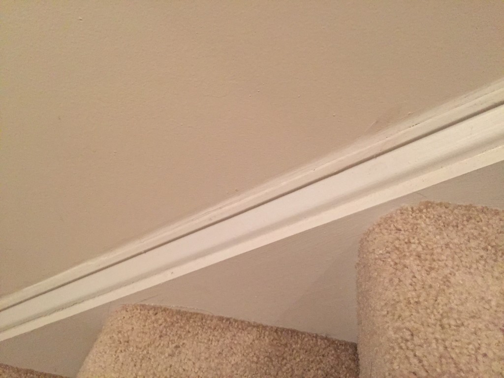 crack by stairs of home concealed after caulking job