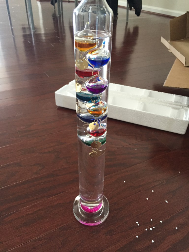 galileo thermometer with broken pink globe at bottom