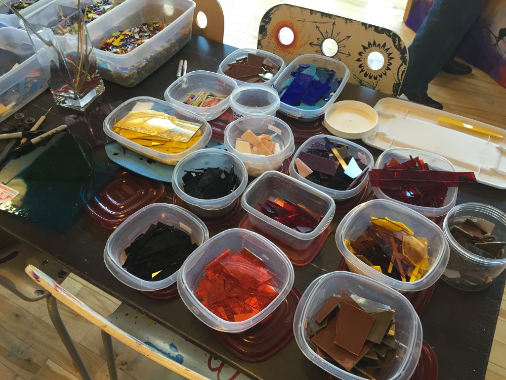 pieces of colored glass sorted into plastic tubs