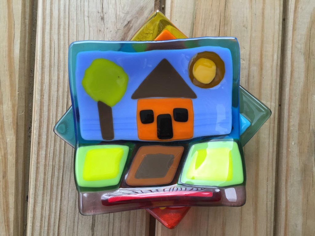 house glass plate layered over geometric glass plate