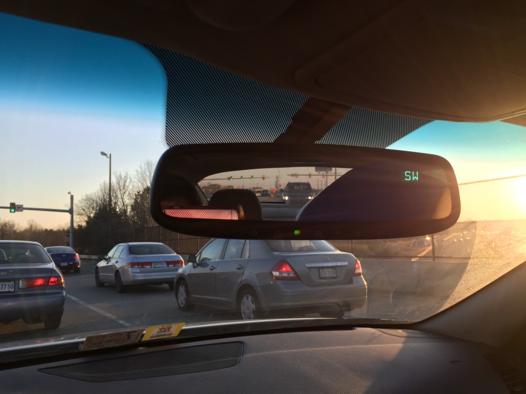 view of giant beach ball in rearview mirror of car