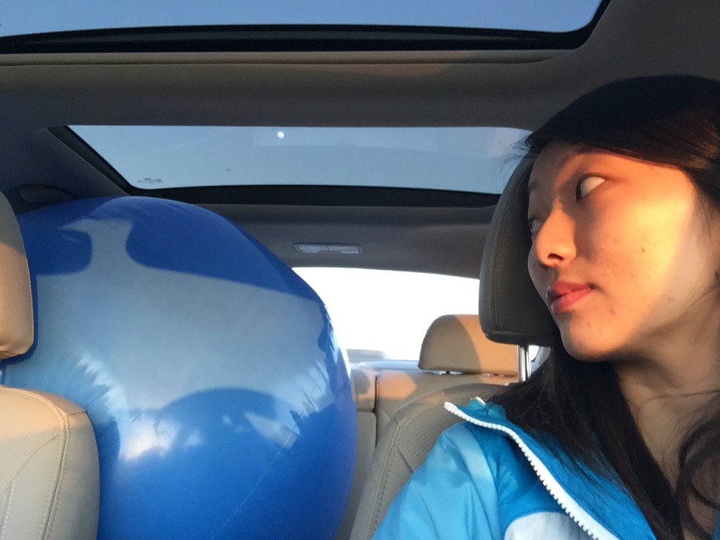 selfie in car with giant blue beach ball in back seat