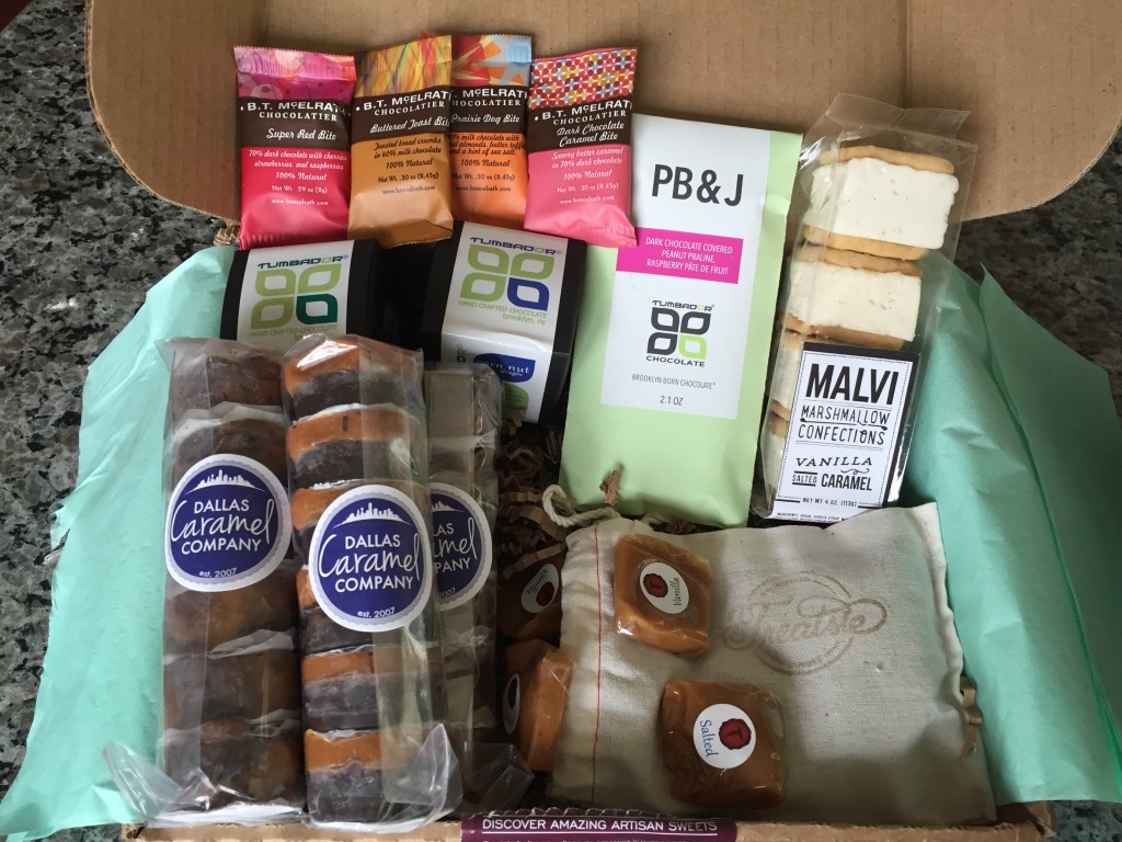 treatsie april 2015 box contents with b. t. mcelrath chocolate bites, tumbador chocolate , malvi marshmallow confections cookie sandwich with dallas caramel co armadillos and horned toads and tahana confections caramels