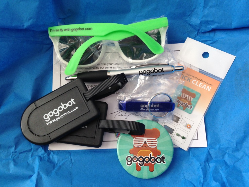 gogobot pro 2014 sunglasses, pen, luggage tags, bottle opener, screen wipe sticker, and pin